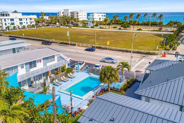Aerial view of Lauderdale-by-the-Sea pool property with ocean in background